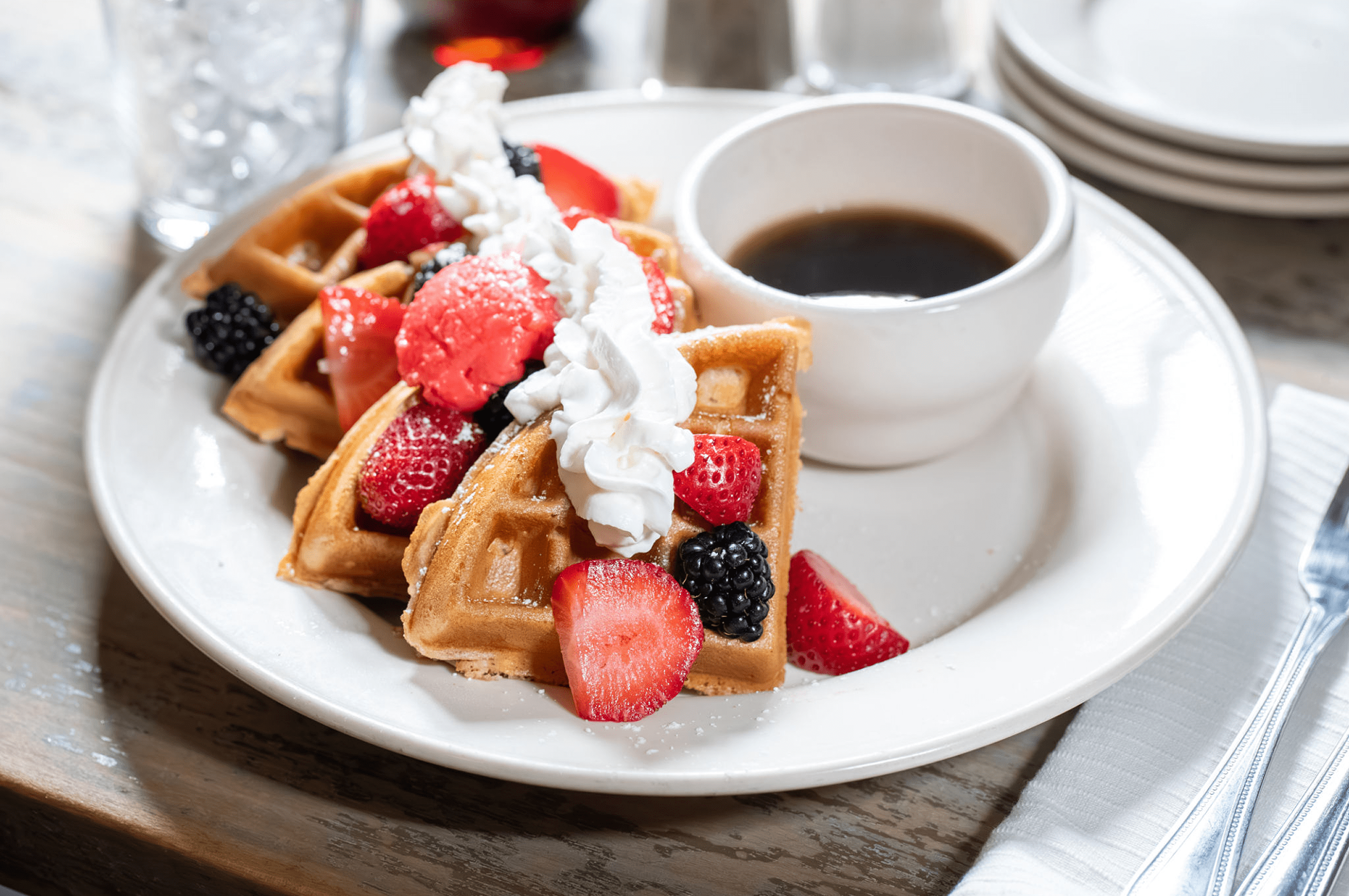 Fresh waffles topped with fruit and cream